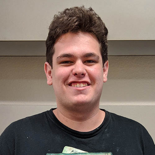 Headshot of Nick Barth, a smiling white man with short brown hair and a black T-shirt.