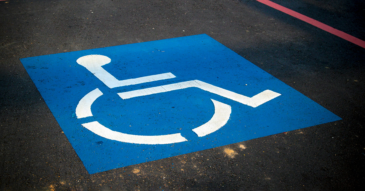 A handicap sign painted in a parking spot. It evokes thoughts of Accessibility Awareness Week.
