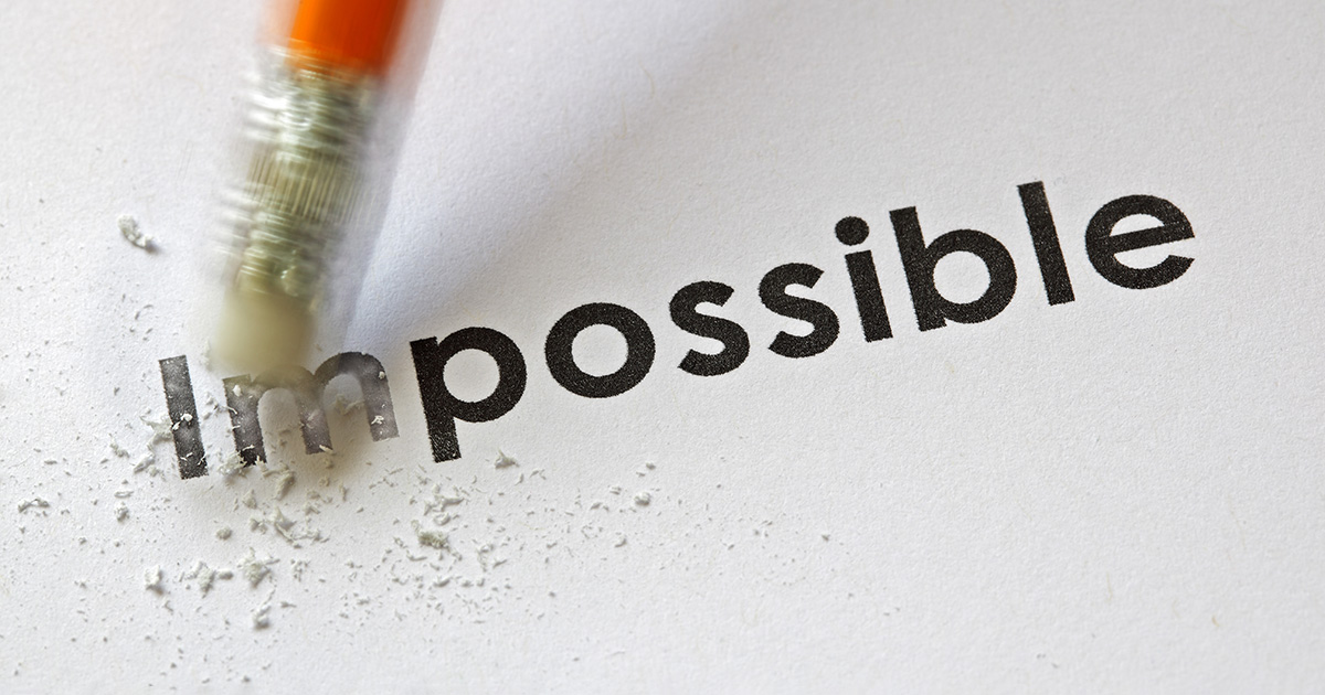 Changing the word impossible to possible with a pencil eraser, symbolizing business class benefits.