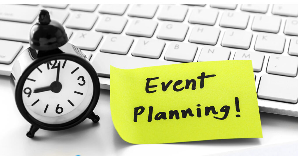 Event planning written on notepad with clock on white computer desk, representing careers in event planning.