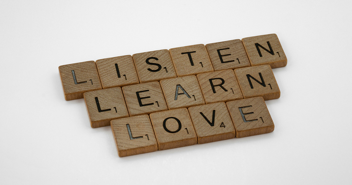 Scrabble tiles spelling the words "listen learn love". The words represent class of 2021 reflections.