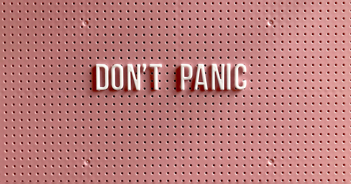 "Don't Panic" written on a pink peg letter board. It evokes thoughts of college back-to-school anxiety.