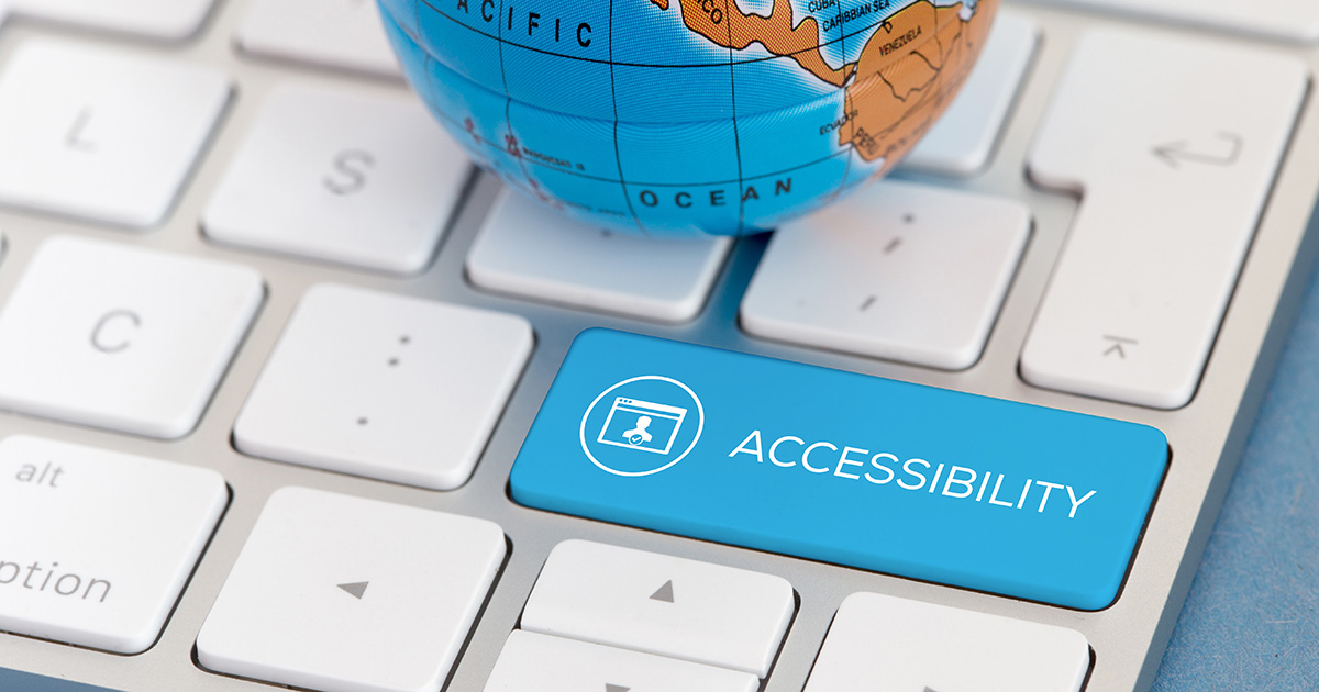 A globe sitting on an Apple keyboard. The shift key on the keyboard says "ACCESSIBILITY," representing the college disability accommodations process.
