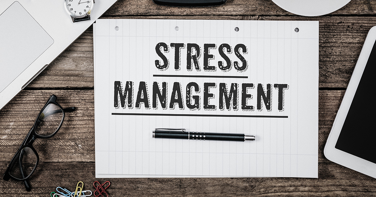 Stress Management statement on paper note pad. Combating college stress leads to success.