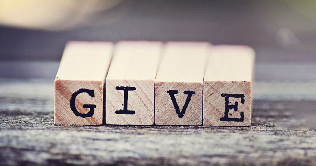 Wooden blocks with "Give" printed on them. representing the mission of EFSC Alumni Support.