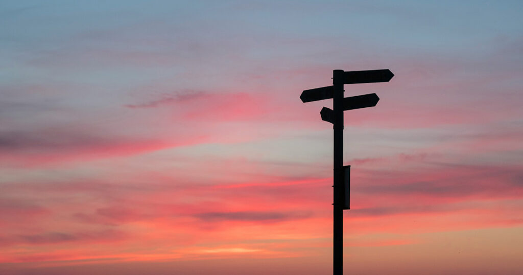 The silhouette of a street sign with a sunset in the background. The street sign represents the various pathways to EFSC Workforce Readiness.