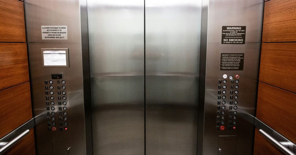 The interior of an elevator, facing the doors and buttons. It evokes thoughts of creating the perfect elevator pitch.