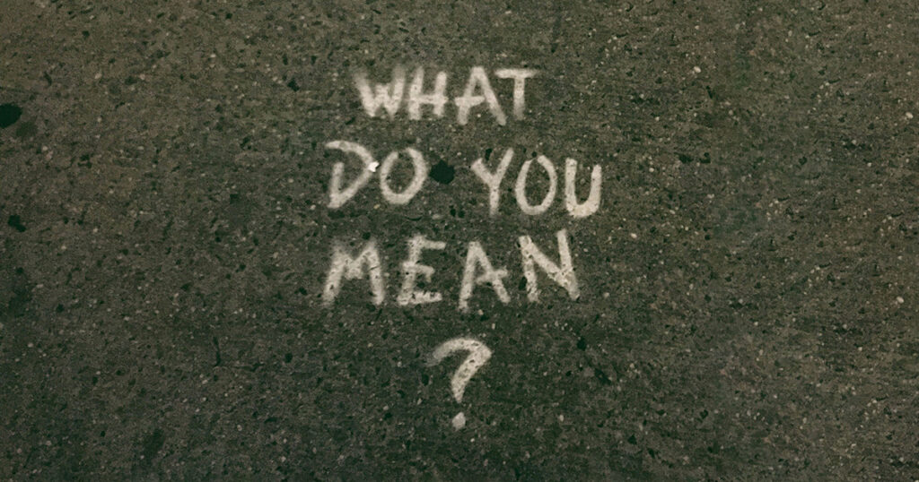 "What do you mean?" written in white chalk on a sidewalk. This question evokes thoughts of interview question tips.