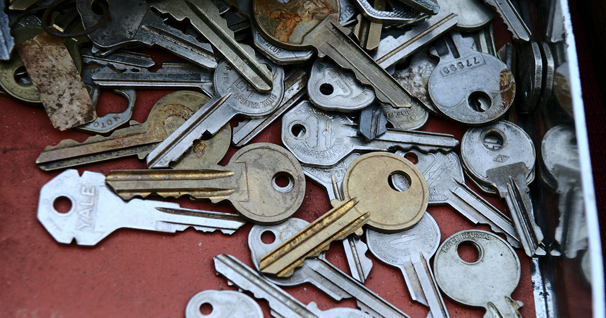 A pile of different kinds of metal keys on a red surface, symbolizing self-advocacy skills.
