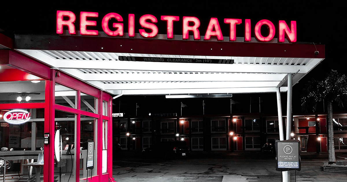 A motel car port with a neon sign on top that reads "registration". A lobby area with a open sign. It symbolizes the many steps to success.