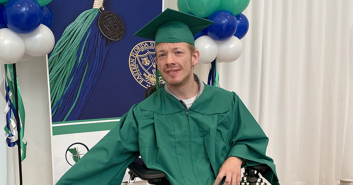 Justin Miller in Eastern Florida State College green bachelor graduates robes, representing students with disabilities.
