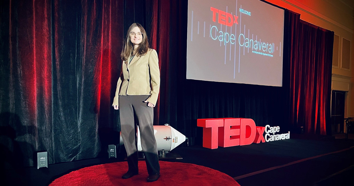 Casey Covel standing on the stage at Ted Talk x Cape Canaveral. Having given a TEDx Talk, Casey feels experienced to give some TED Talk preparation tips.