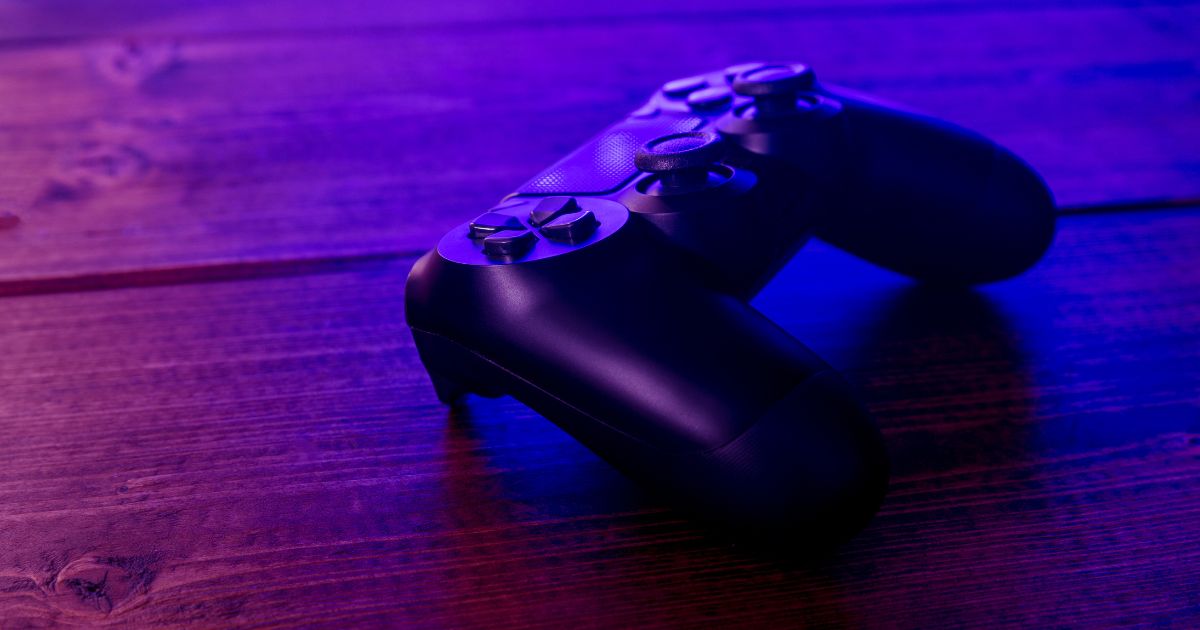 A PlayStation controller on a wooden floor under blue-purple lighting might inspire you to consider gamifying your to-do list.