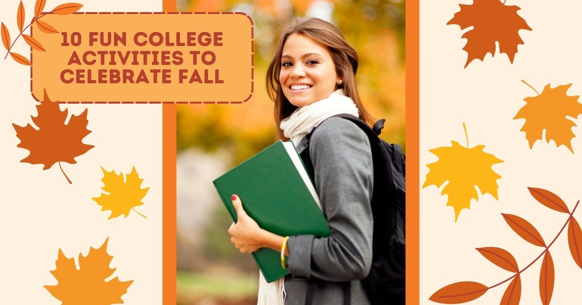 A female college student in a sweater holding a green binder smiling at the camera with fall colored trees behind her.