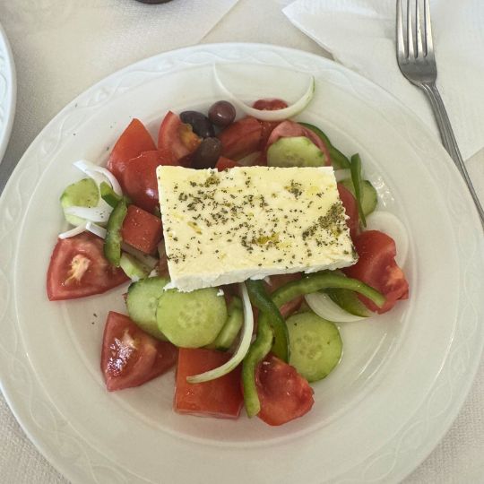 A Greek dish consisting of tomatoes, cucumbers, and cheese or tofu