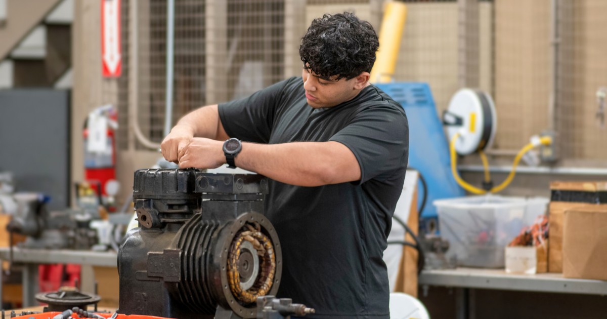 A student in EFSC's HVAC college program works on a motor.