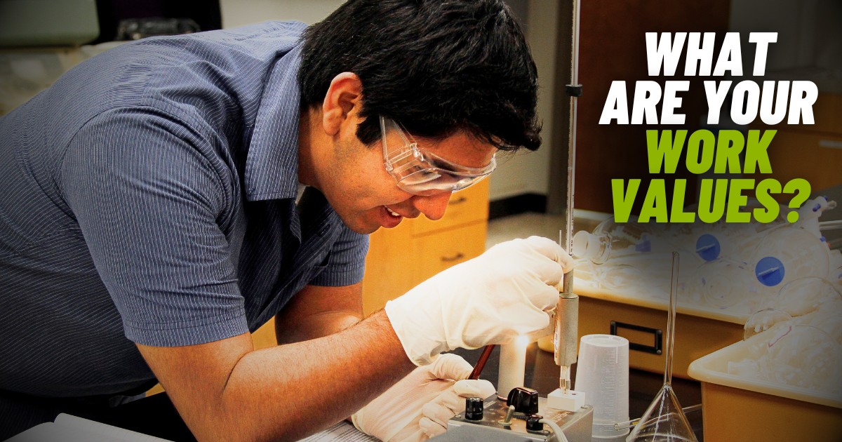 A student wearing protective lab goggles and gloves works on an apparatus, an example of his work value being achievement.