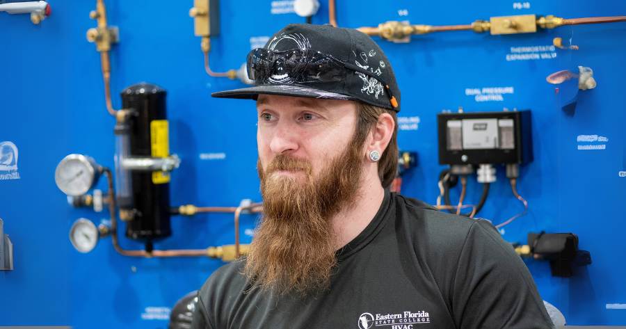 Nicholas Viet, a man with a long beard and a ballcap wearing a black EFSC t-shirt