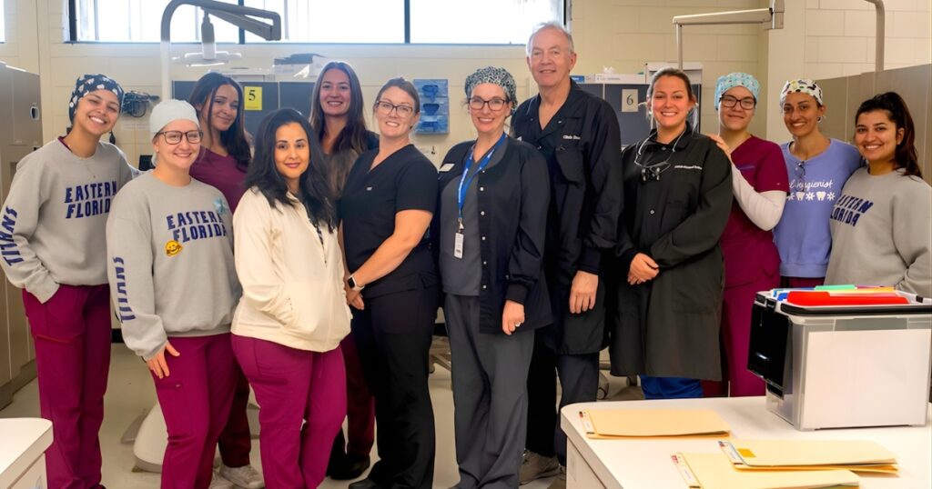Group of EFSC dental students and teachers standing in a dental exam room