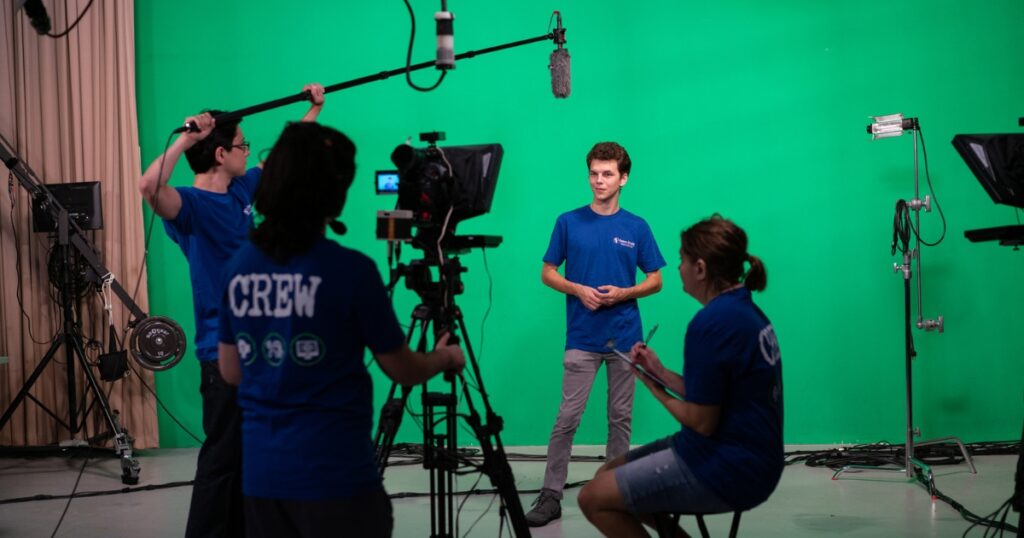College students in EFSC's Interactive Media program filming using a green screen and other equipment