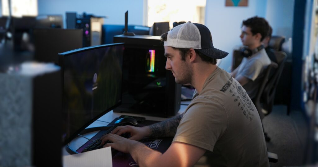 Student sits at computer desk accessing online tools